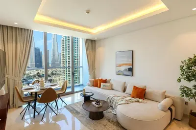a living room with a couch and a table at HiGuests - City Elegance 1BR in The Sterling by Omniyat in Dubai