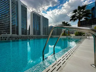 a swimming pool in a city with tall buildings at HiGuests - City Elegance 1BR in The Sterling by Omniyat in Dubai