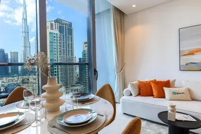 a living room with a couch and a table at HiGuests - City Elegance 1BR in The Sterling by Omniyat in Dubai