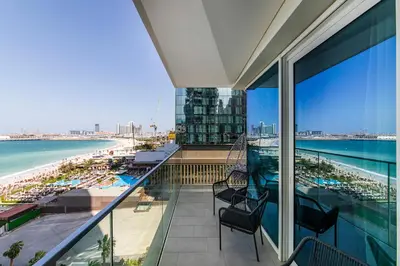 a balcony with chairs and a view of the beach at Luxury apartments at La Vie in Dubai