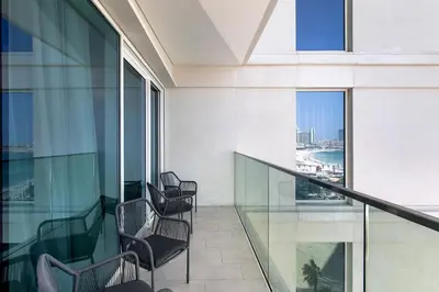 a balcony in a building with chairs looking out at the city at Luxury apartments at La Vie in Dubai