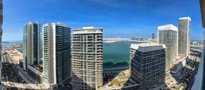 an aerial view of a city with tall buildings at Marvelous 1BD Sea View Apartment with Beach Access in Dubai