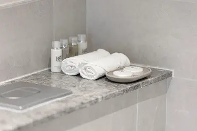 a bathroom counter with towels and a laptop on it at Forte Tower 1 - Fantastic Two Bedroom in Downtown Dubai in Dubai