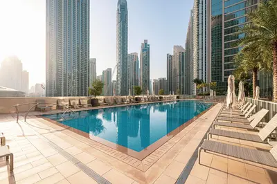 a pool in the middle of a city with tall buildings at Forte Tower 1 - Fantastic Two Bedroom in Downtown Dubai in Dubai