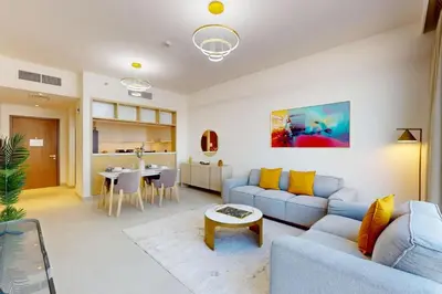a living room with a couch and a table at Locations I Creek Harbor I Premium Modern 2BR I Luxury Interiors & Comfortable Stay I Close to Dubai Canal, Dining & Shopping I Pool, Gym & Parking in Dubai