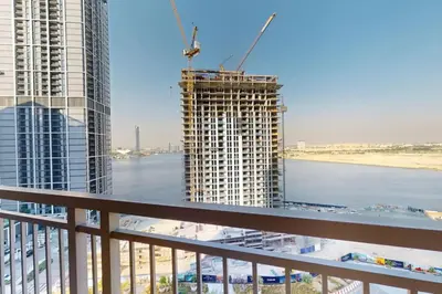 a view from a balcony of a building under construction at Locations I Creek Harbor I Premium Modern 2BR I Luxury Interiors & Comfortable Stay I Close to Dubai Canal, Dining & Shopping I Pool, Gym & Parking in Dubai