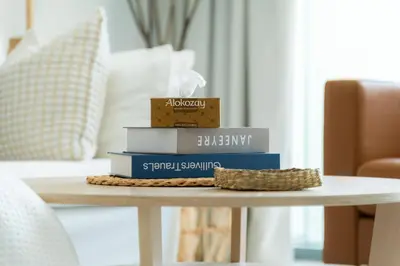 a pile of books sitting on a table at Elite Escape Holiday Home - 2 BHK Getaway with Burj Khalifa View and Dubai Mall Access - 1504 in Dubai