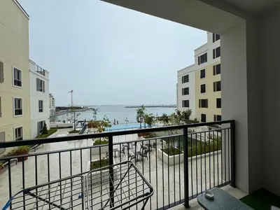 a view of the ocean from a balcony of a building at Brand New 2BR in La Rive with SeaView, Pool & Gym in Dubai