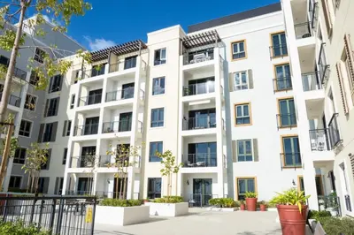 an image of a white apartment building at Brand New 2BR in La Rive with SeaView, Pool & Gym in Dubai