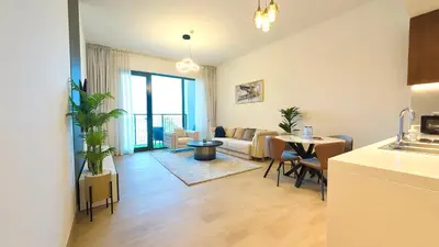 a living room with a couch and a table at Brand New 2BR in La Rive with SeaView, Pool & Gym in Dubai