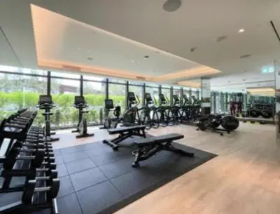 a gym with rows of treadmills and exercise bikes at #25 High end 2BR in The Address Dubai Opera in Dubai
