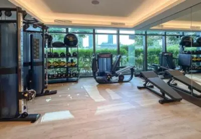 a gym with treadmills and machines in a room at #25 High end 2BR in The Address Dubai Opera in Dubai