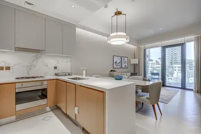 a kitchen with a table and a dining room at #25 High end 2BR in The Address Dubai Opera in Dubai