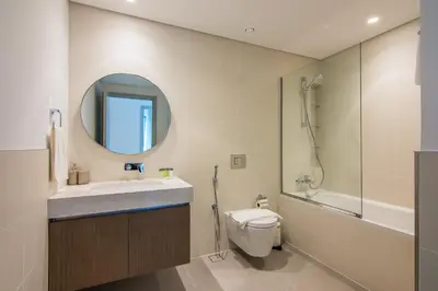 a bathroom with a toilet and a sink and a mirror at Luxe Living in Beachfront 2 Bedroom in Dubai Marina in Dubai