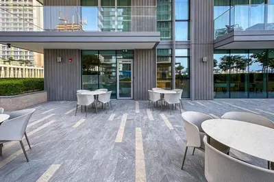 a patio with tables and chairs in a building at Luxe Living in Beachfront 2 Bedroom in Dubai Marina in Dubai