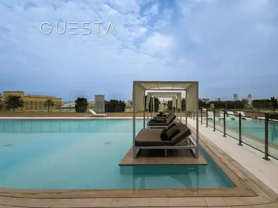 a hotel swimming pool with a sign that reads guesta at Binghatti Crescent, Jumeirah Village Circle in Dubai