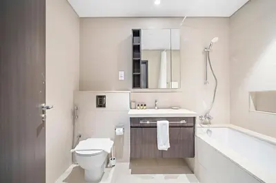 a bathroom with a toilet and a sink and a tub at Silkhaus Heart of Downtown High Floor with View in Dubai