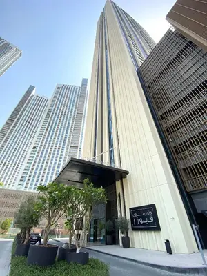 a tall building with a sign in front of it at Silkhaus Heart of Downtown High Floor with View in Dubai