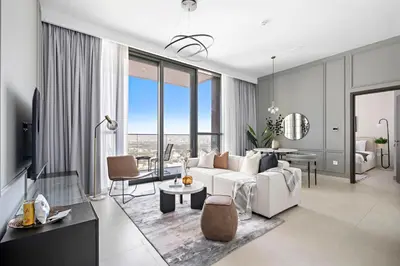 a living room with a white couch and a table at Silkhaus Heart of Downtown High Floor with View in Dubai