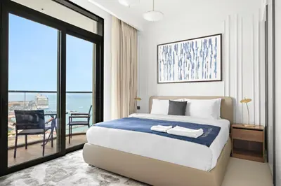 a bedroom with a bed and a view of the ocean at Silkhaus Sunset & Sea View in a Tower Private Beach in Dubai