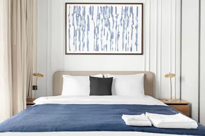 a bedroom with a large bed with a blue blanket at Silkhaus Sunset & Sea View in a Tower Private Beach in Dubai