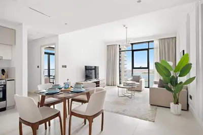 a kitchen and living room with a table and chairs at Silkhaus Sunset & Sea View in a Tower Private Beach in Dubai