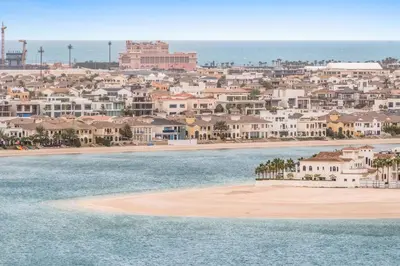 a view of a beach with houses and the ocean at Silkhaus Sunset & Sea View in a Tower Private Beach in Dubai