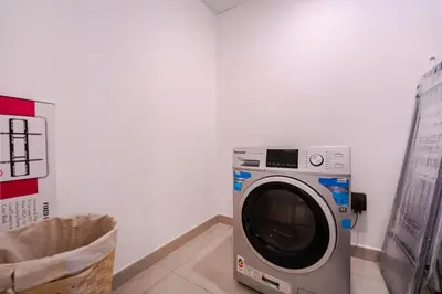 a washing machine in a room next to a wall at Peaceful 2BR Retreat Near Burj Al Arab in Dubai