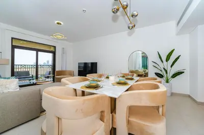 a dining room with a table and chairs at Peaceful 2BR Retreat Near Burj Al Arab in Dubai