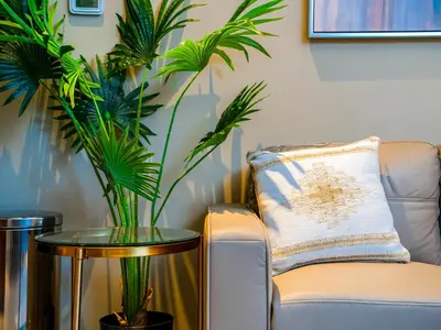 a living room with a chair and a table with plants at Cozy Studio with Burj Khalifa Views in Dubai