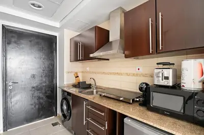 a kitchen with a sink and a microwave at StoneTree - Cozy Studio - JLT in Dubai