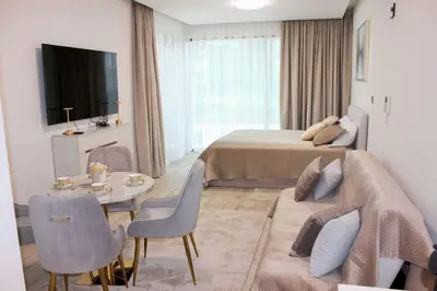 a hotel room with a bed and a couch and a table at Розкішна квартира з видом на Бурж Халіфа in Dubai