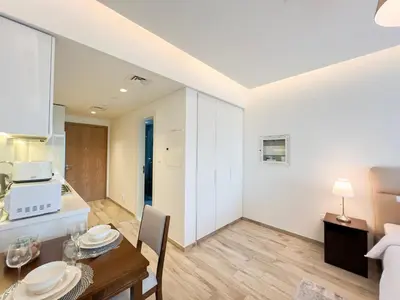 a kitchen and dining room with a table and a microwave at Luxury Studio with Unobstructed Burj Khalifa View - 23AB08 in Dubai