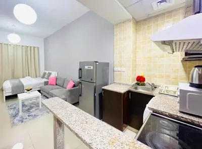 a kitchen and living room with a stainless steel refrigerator at Studio Apartment in Dubai Marina with Balcony in Dubai