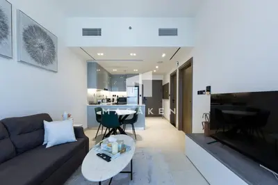 a living room with a couch and a table at Stylish 1br Business Bay W Burj Views in Dubai