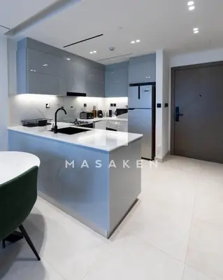 a kitchen with a sink and a refrigerator at Stylish 1br Business Bay W Burj Views in Dubai