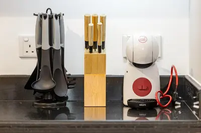 a kitchen counter with a mixer and some knives at Classic 1 Bed Suite in The Residence Tower 3 in Dubai