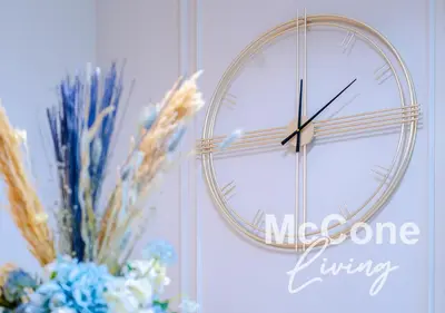 a clock on a wall with a vase of flowers at Classic 1 Bed Suite in Burj Vista Tower, Downtown in Dubai