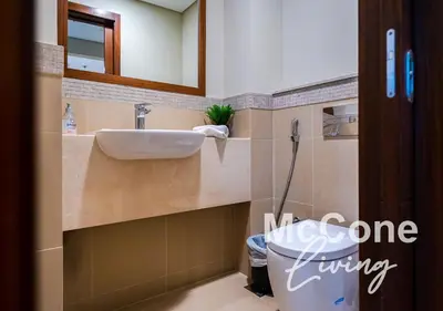 a bathroom with a sink and a toilet at Classic 1 Bed Suite in Burj Vista Tower, Downtown in Dubai