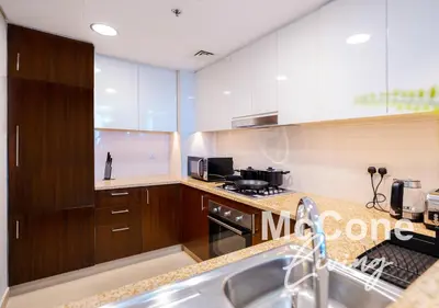 a kitchen with a sink and a stove at Classic 1 Bed Suite in Burj Vista Tower, Downtown in Dubai