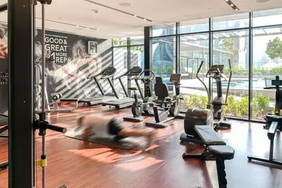 a gym with a bunch of treadmills and machines at Frank Porter - DT1 Tower in Dubai