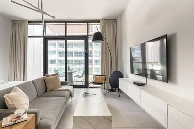 a living room with a couch and a tv at Frank Porter - DT1 Tower in Dubai
