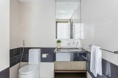 a bathroom with a toilet and a sink at Frank Porter - The Lofts West in Dubai