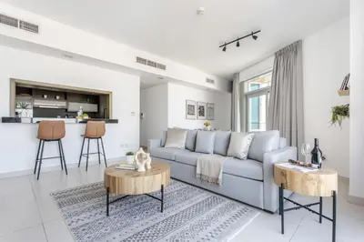 a living room with a couch and a table at Frank Porter - The Lofts West in Dubai