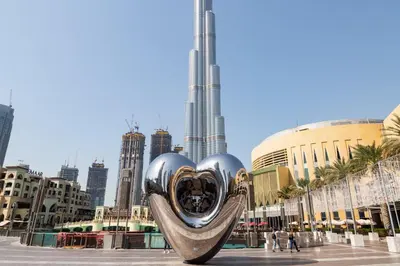 a sculpture of a heart in the middle of a city at Frank Porter - The Lofts West in Dubai