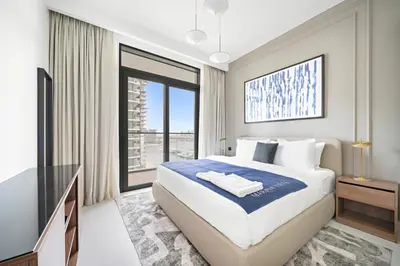 a bedroom with a large bed and a large window at Silkhaus Tower with Private Beach and Skyline Views in Dubai