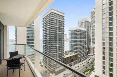 an apartment balcony with a view of a city at Silkhaus Tower with Private Beach and Skyline Views in Dubai
