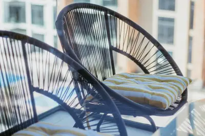 a chair with a pillow sitting on a balcony at Modern Oasis: Spacious Studio Near Dubai Downtown in Dubai