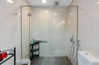 a shower with a glass door in a bathroom at Burj Daman, DIFC Dubai - Mint Stay in Dubai