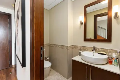 a bathroom with a sink and a toilet and a mirror at Burj Daman, DIFC Dubai - Mint Stay in Dubai